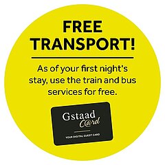 Yellow dot with black text «Free transport! - As of your first night's stay, use the train and bus services for free», plus the black, white and gold Gstaad Card logo.