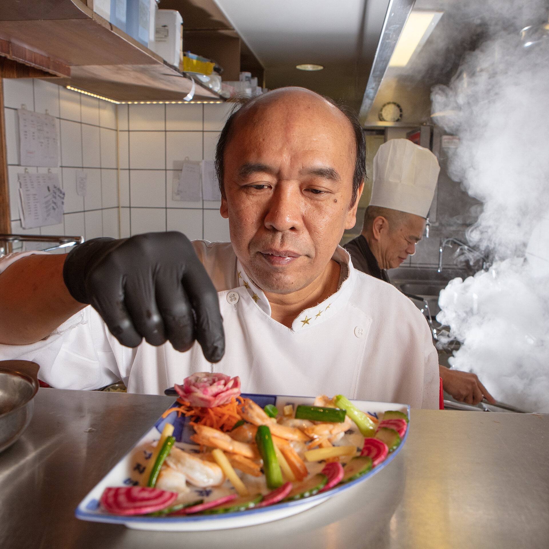 Koch stellt in Küche chinesisches Essen her.